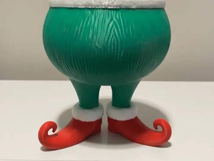 Animation of a hand holding the darker green bowl by its legs